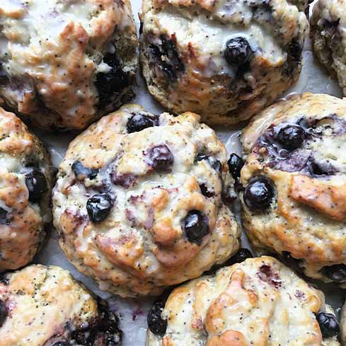 Fresh, glazed, blueberry scones.